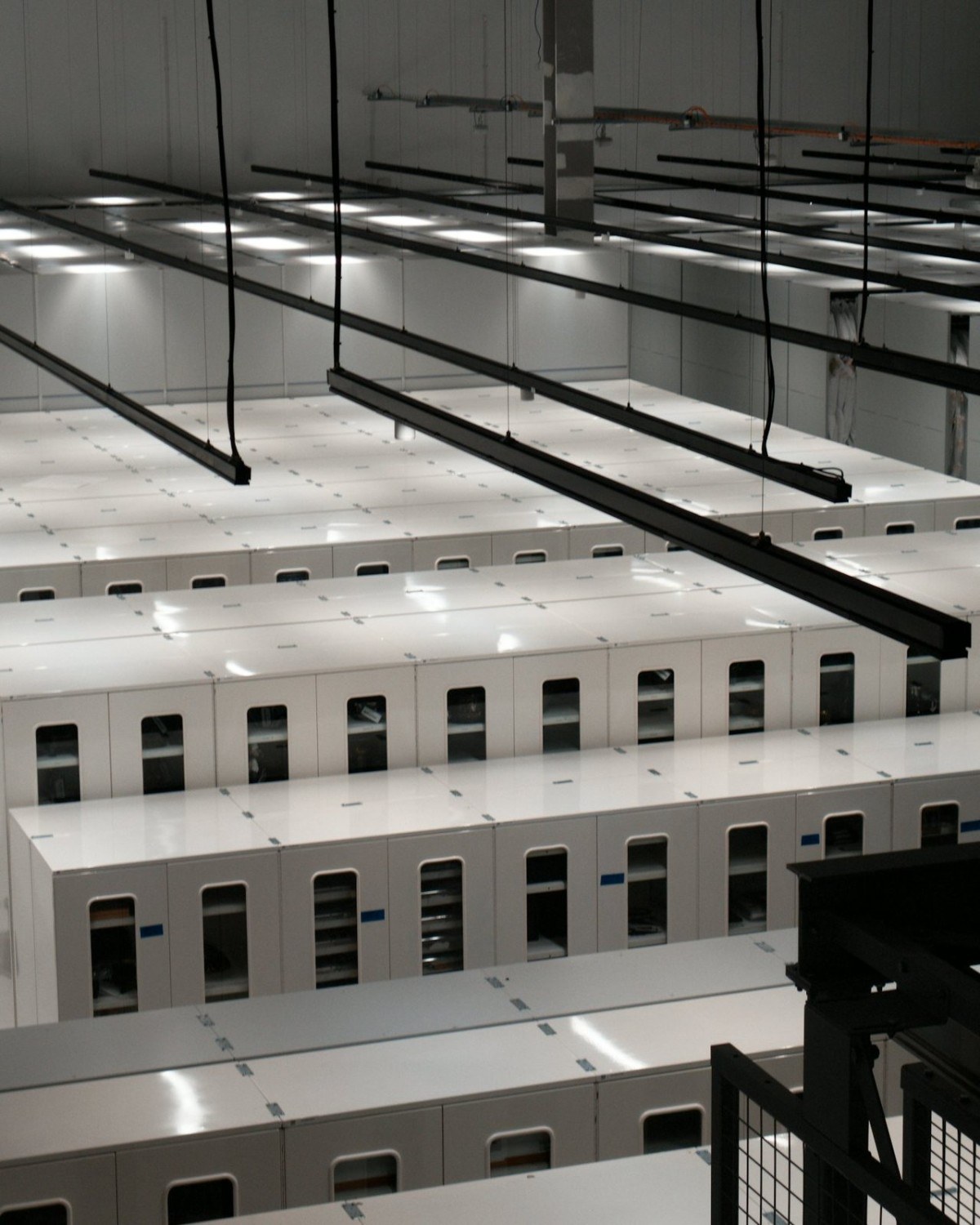 Rows of white server cabinets in an air-cooled data hall